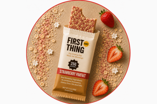 A wrapped Strawberry Parfait bar photographed from above with a bite taken out of the top, framed in a red circle, with strawberries and oats around it