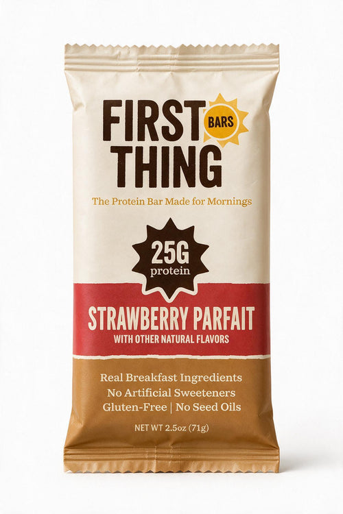 A sealed First Thing Strawberry Parfait bar wrapper, front view: 25G protein, Real Breakfast Ingredients, No Artificial Sweeteners, Gluten-Free, No Seed Oils, net weight 2.5 oz (71 g)